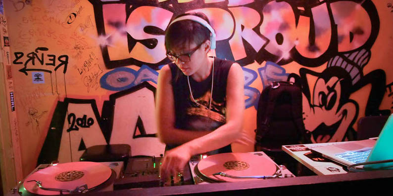 woman DJ spinning a record